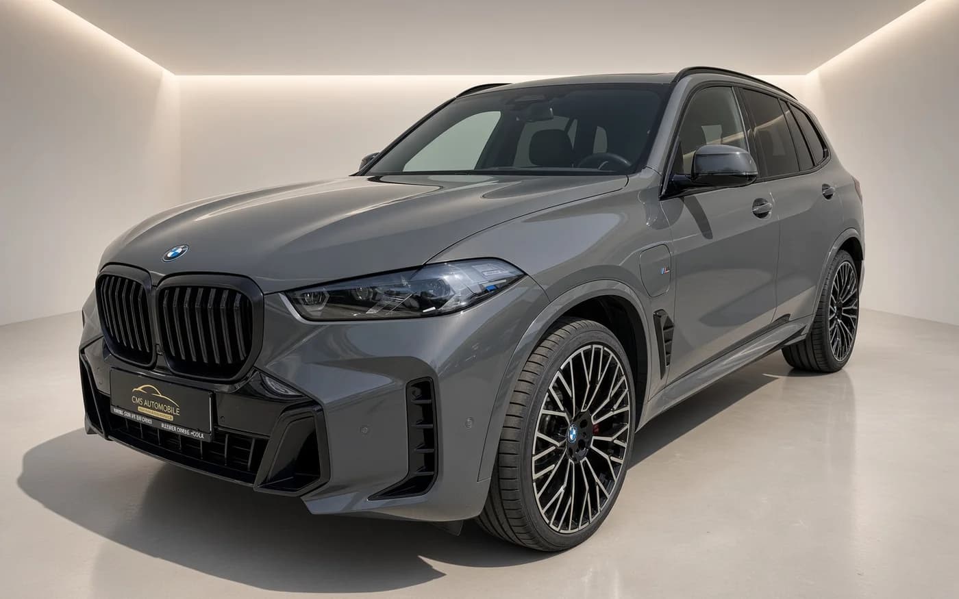 The same grey BMW X5 in a polished studio setting after AutoStudio